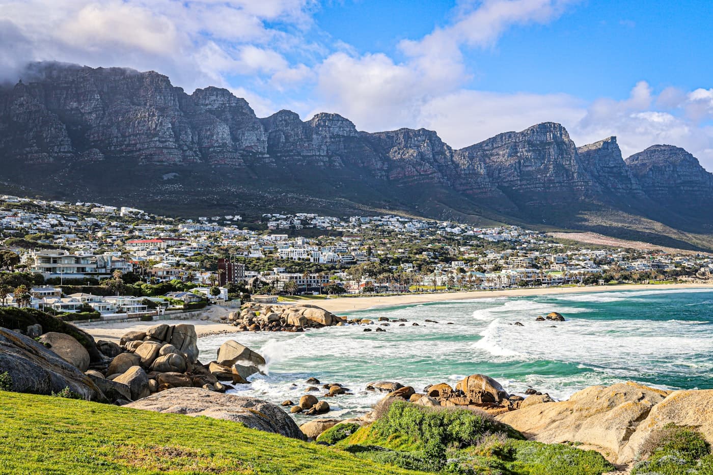 A view of a beach with mountains in the background